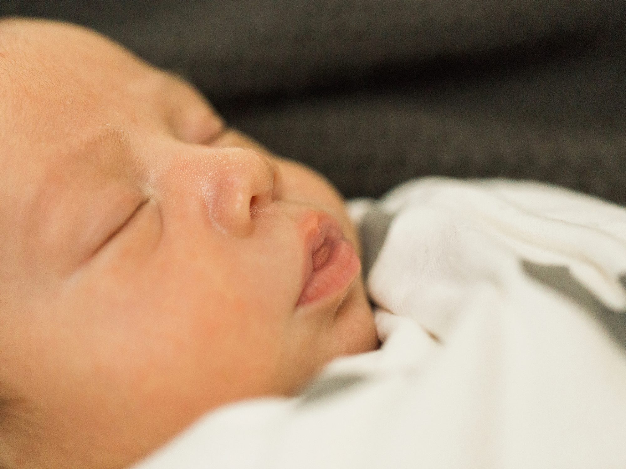 an up close portrait of newborn baby's face taken by j. photography
